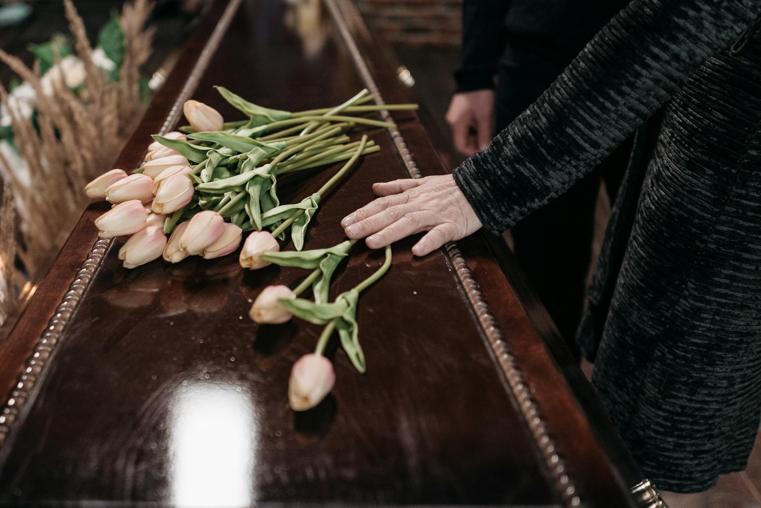 Flowers placed on a wooden coffin